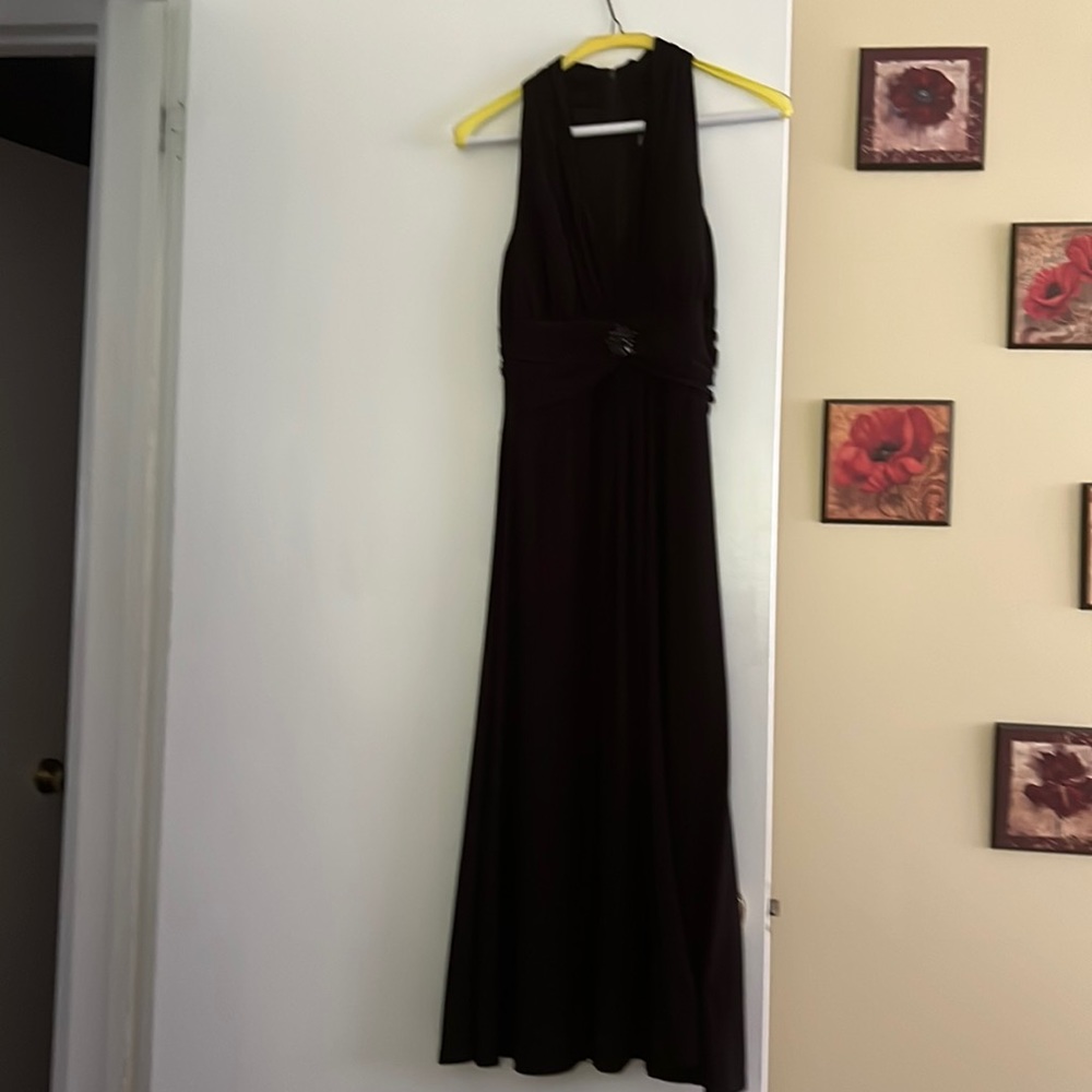 Black tea length cocktail dress. With waist embellishment. Sleeveless
